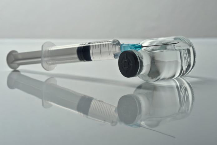 Photo of a syringe and vial of medicine
