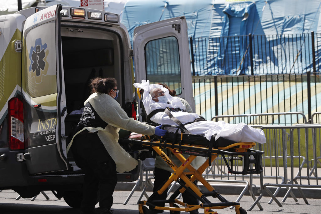 Photo of elderly patient being placed into an ambulance