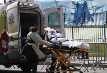 Photo of elderly patient being placed into an ambulance