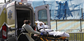 Photo of elderly patient being placed into an ambulance