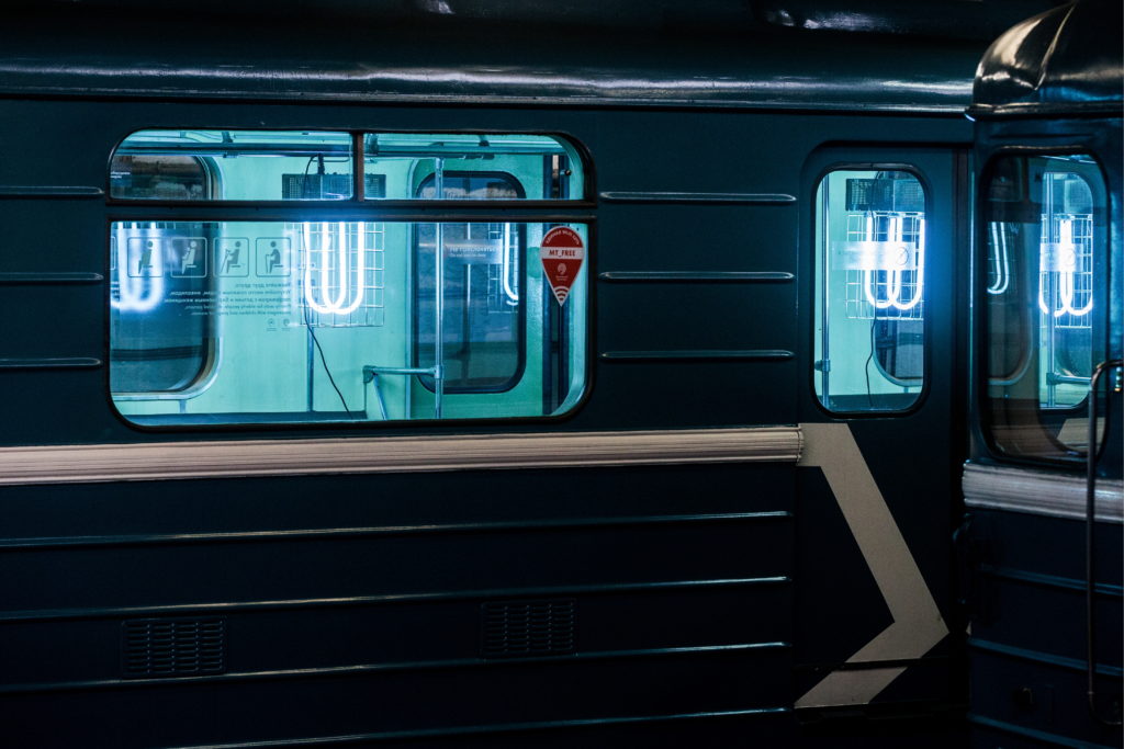 Photo of workers disinfecting subway car with UV light