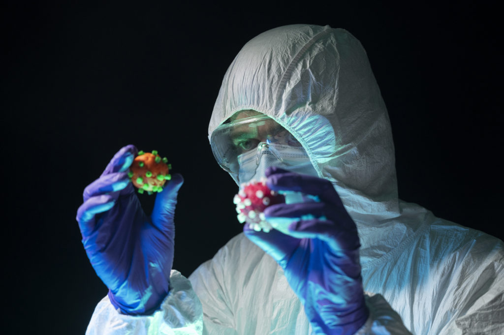 Photo of scientist holding virus models