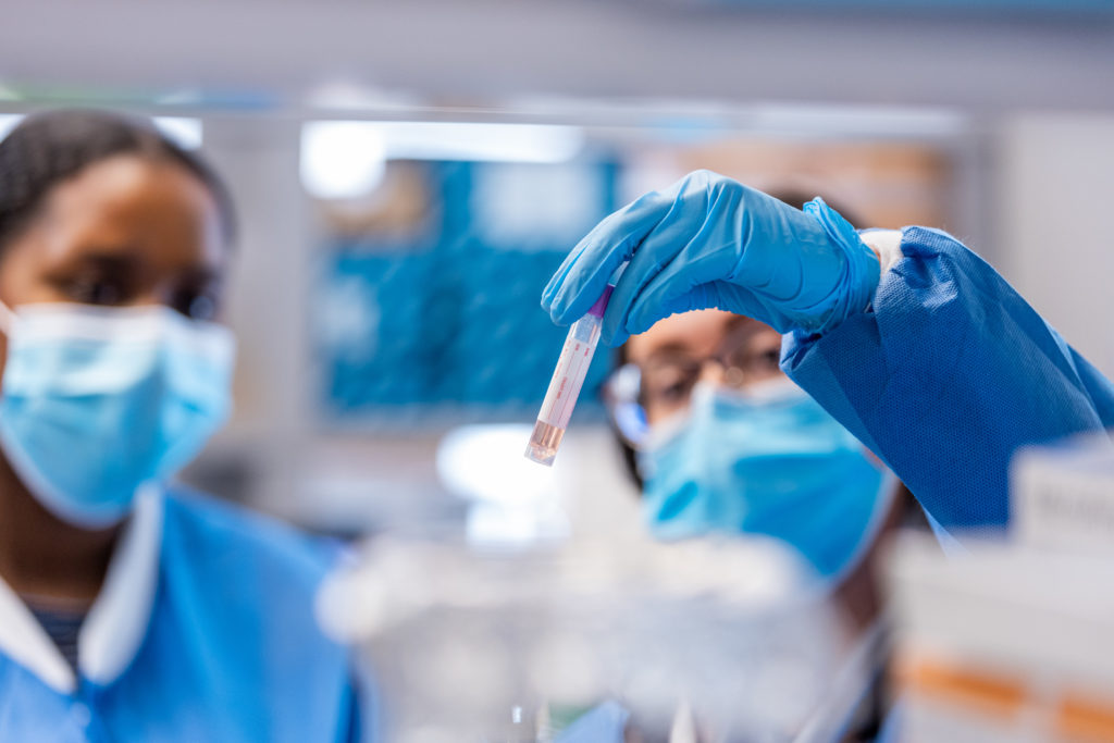 Photo of Scientists examining vial of blood
