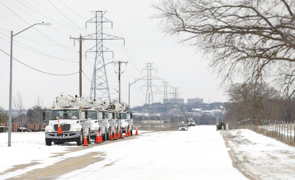 Photo of electrical power crews and trucks