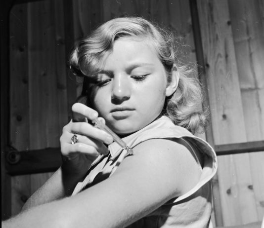 Photo of young girl injecting herself with insulin