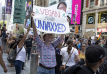 Photo of anti-vax protestors in a crowded street