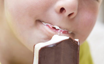 Photo of child eating ice cream sandwich