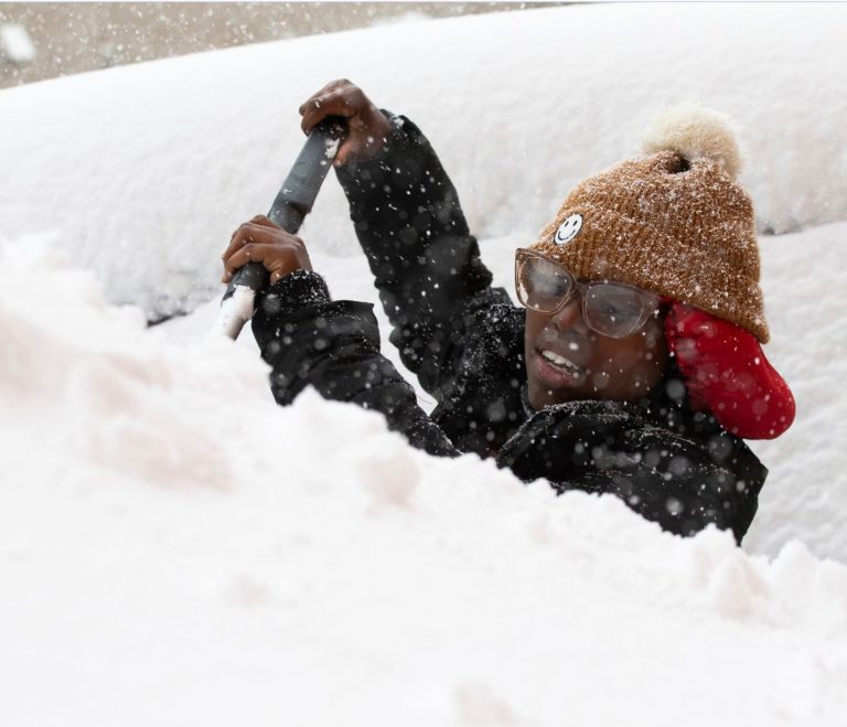 Photo of person shoveling very deep snow
