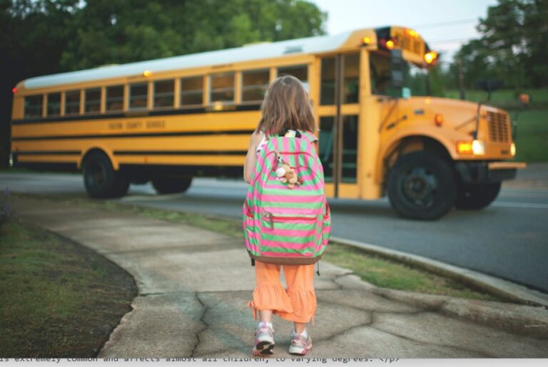 Photograph of a small child walking towards a school bus