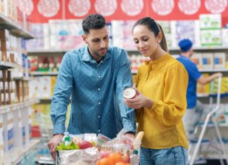Photo of man and woman reading a food label while shopping.